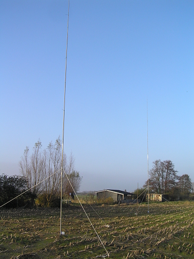 These are two verticals, based on fibreglass masts. The front one is a 1/4 wave antenna for 40m with 16 radials. The rear one is a 5/8 for 20m with 32 radials.